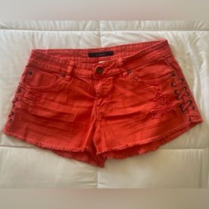 Red Billabong ripped jeans shirts with side crisis-cross design.